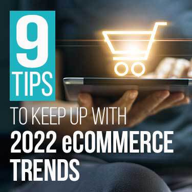 closed laptop in someone's hand with lit up icon of a shopping cart on top